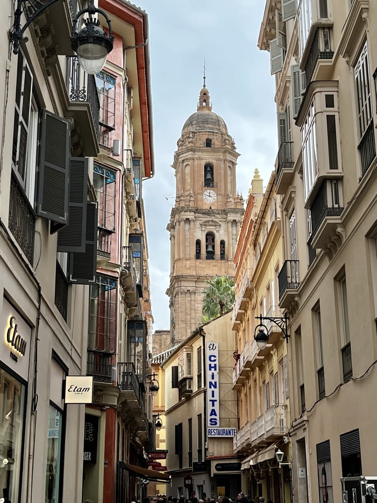 Street in Malaga with the cathedral tower in the background.