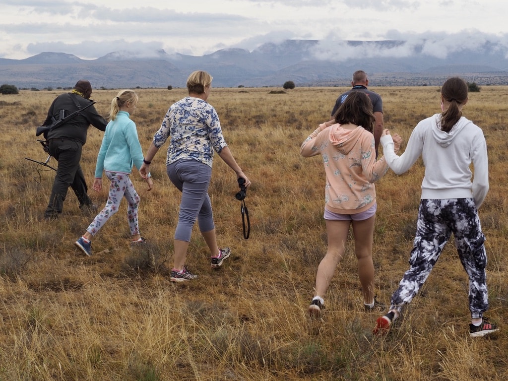 Walking group tracking cheetah in South Africa